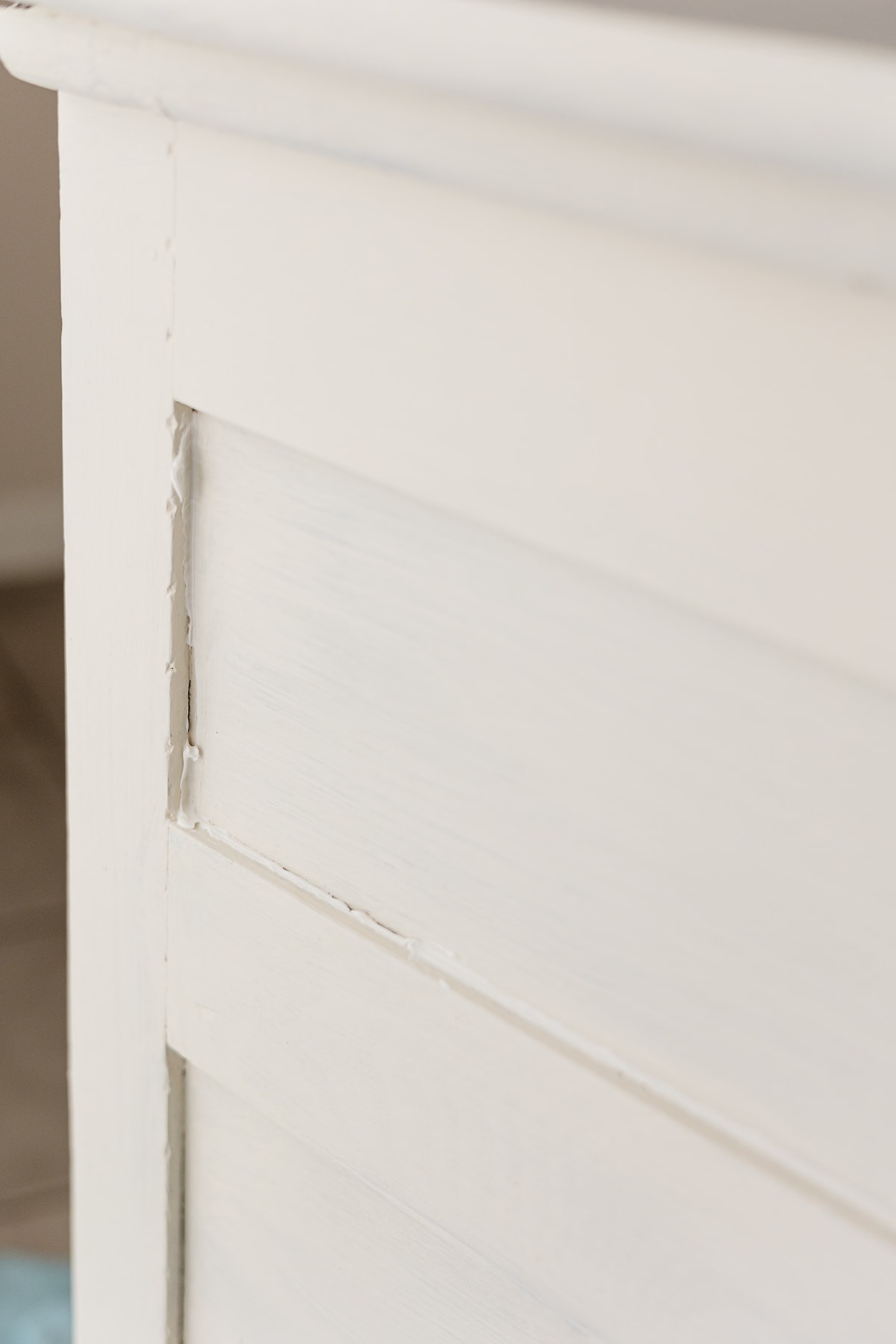 Paintable caulk applied to the seams of a painted dresser.