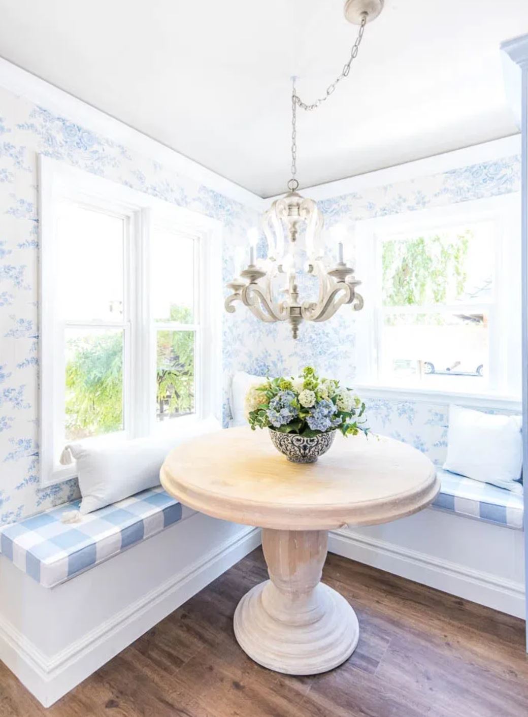 DIY corner banquette seating with buffalo check blue seat cushions.