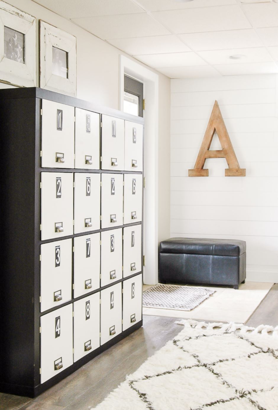 Locker-style black and white IKEA Kallax shelf hack.