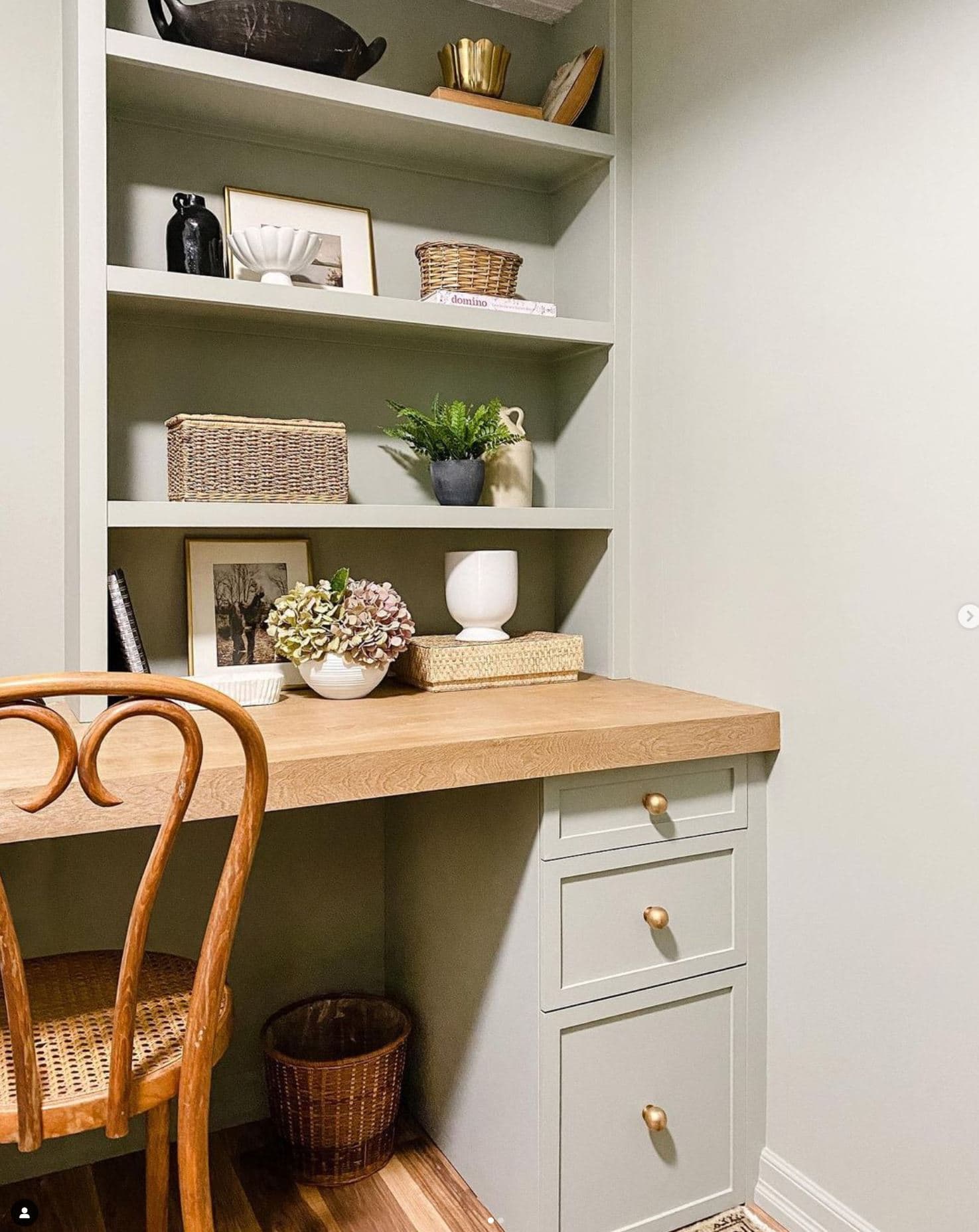 A green desk and drawers with a wooden top hacked from IKEA drawers.