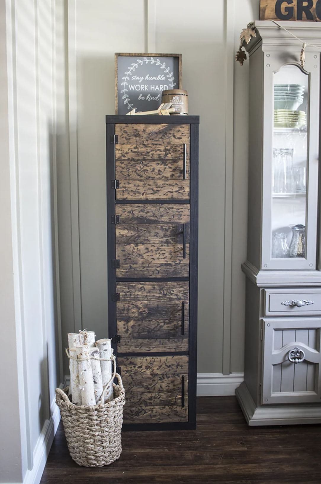 A black IKEA shelf with rustic brown door inserts and handles.