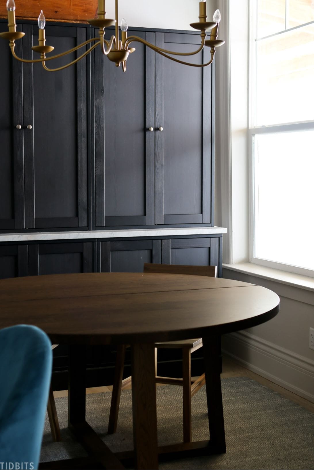 Black IKEA HAVSTA cabinets with a marble slab laid between the halves at about countertop height.