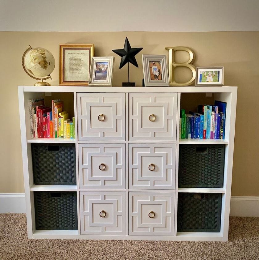 IKEA Kallax hack bookshelf with DIY decorative doors and black storage baskets.