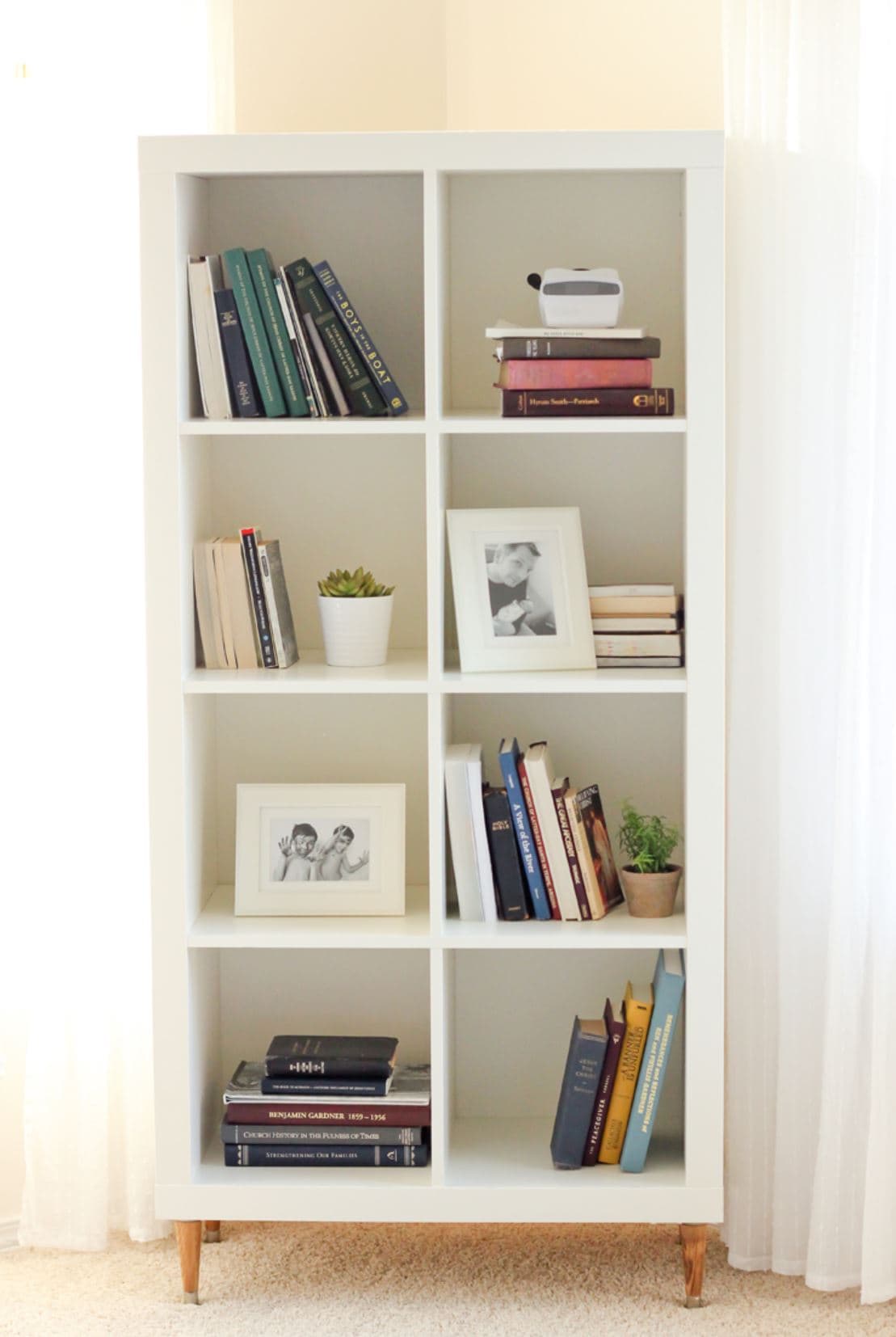 An IKEA bookshelf arranged vertical with added legs.