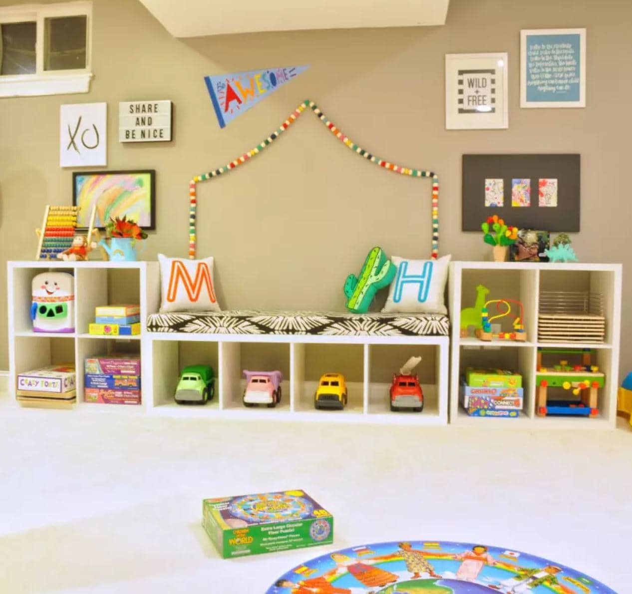 Kids toy storage wall and bench made with IKEA Kallax.