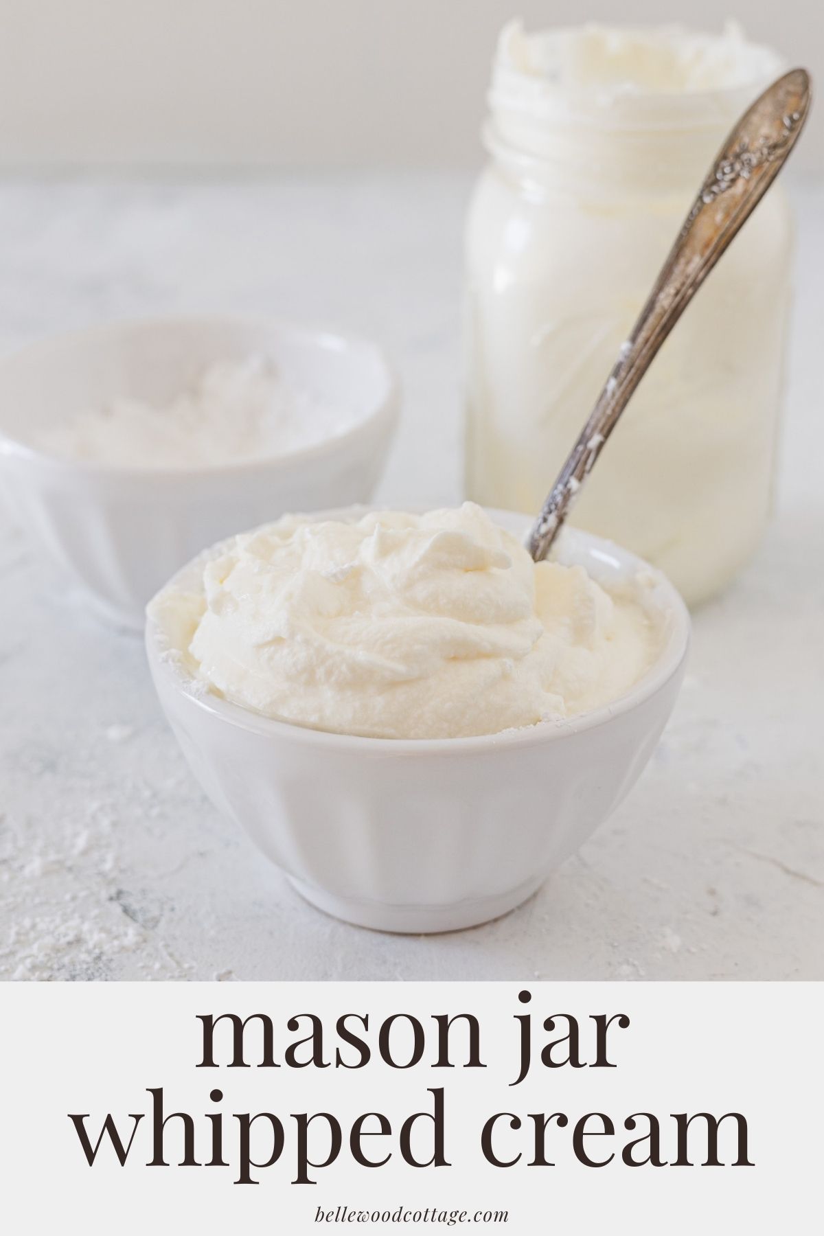 A white bowl filled with whipped cream and a spoon with the words, "mason jar whipped cream".