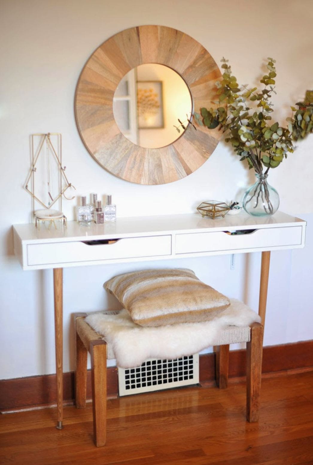 IKEA hack desk for minimal spaces with a bench for seating and mirror above.