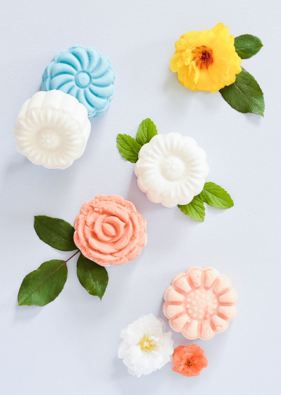 Various colors of bubble bath bars pressed into flower shapes.