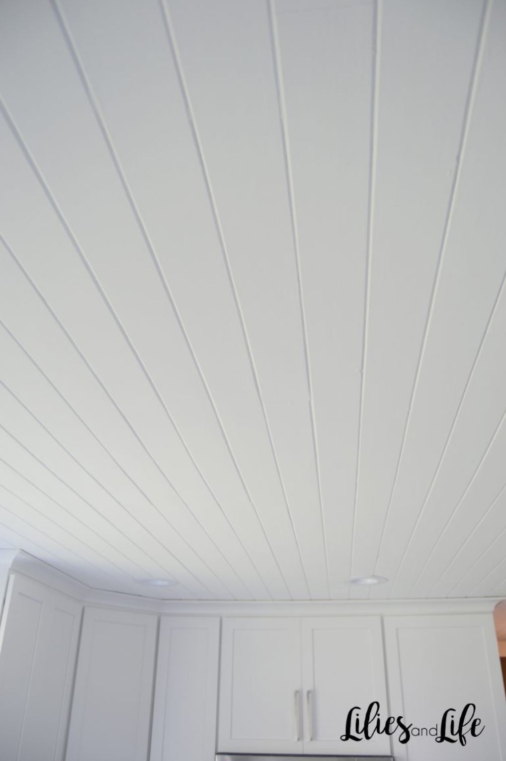 White shiplap style boards on the ceiling of a kitchen.