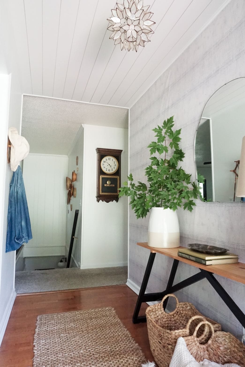 A white shiplap ceiling in a hallway.
