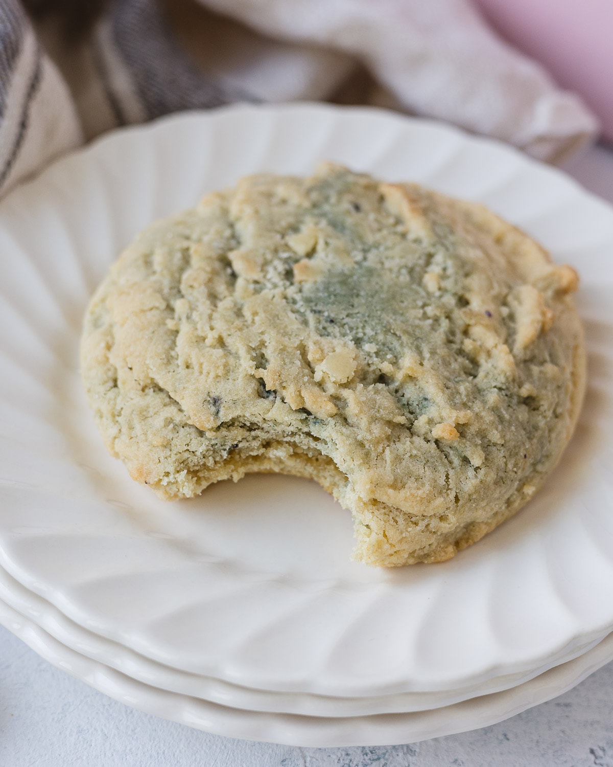 A Crumbl Blueberry Muffin cookie with a bite taken out of it.