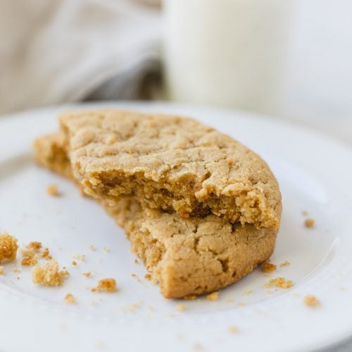 Broken peanut butter cookies stacked on each other.