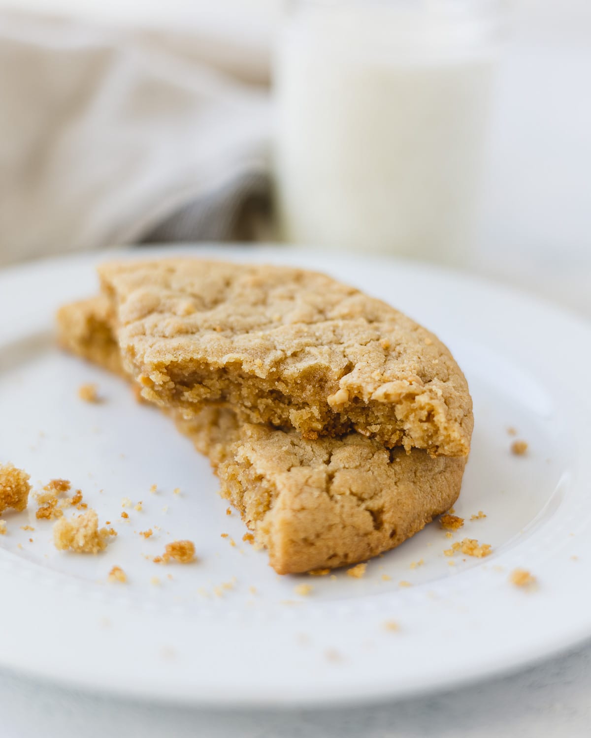 Broken peanut butter cookies stacked on each other.