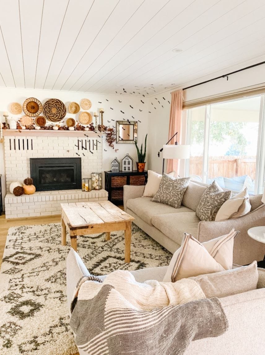 A shiplap ceiling in a cozy living room decorated with rustic decor.