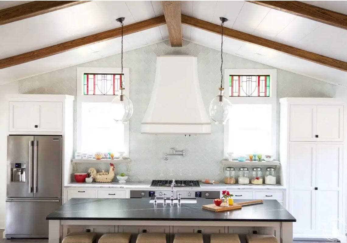 A shiplap ceiling with beams in a large kitchen.