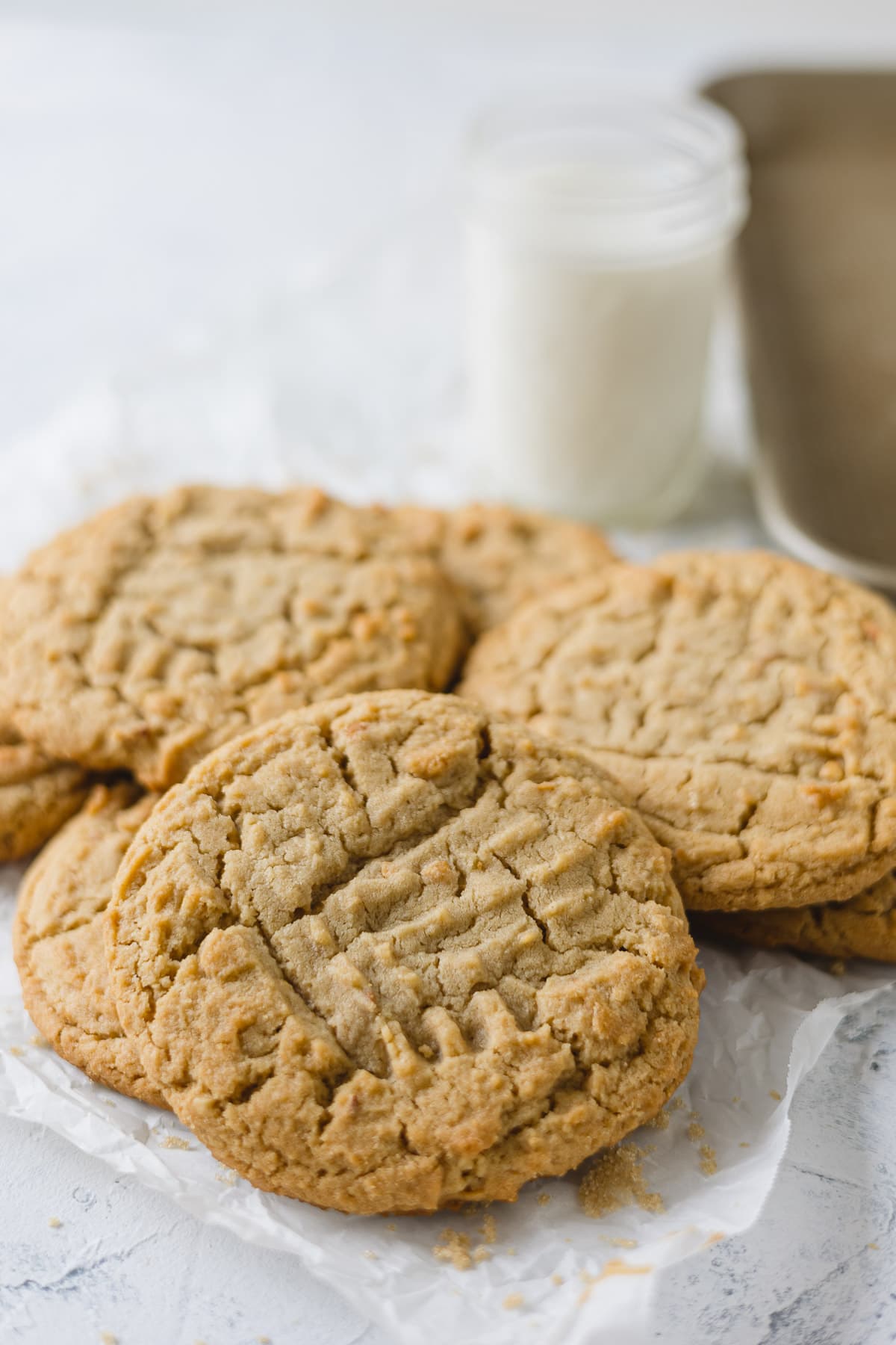 Peanut butter cookies layered on parchment paper.