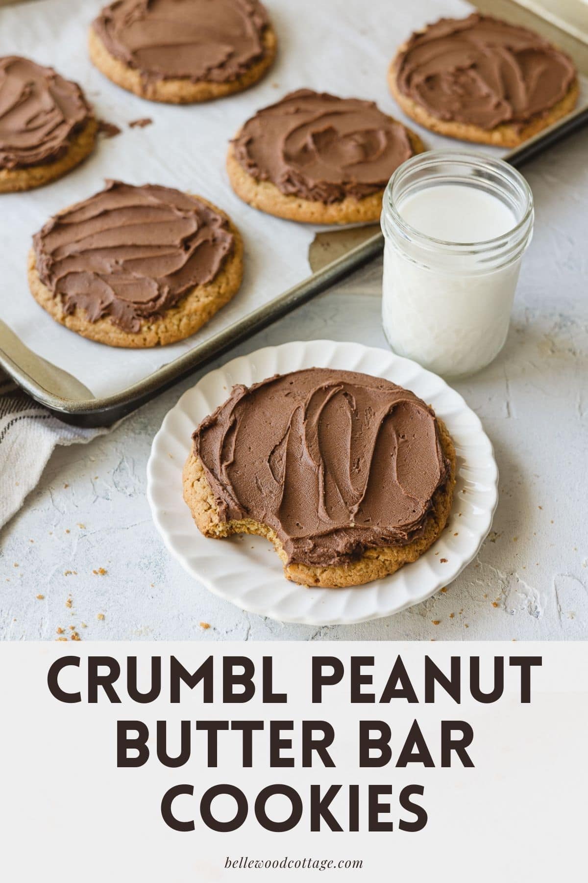 Frosted chocolate peanut butter cookies with the words, "Crumbl Peanut Butter Bar Cookies."