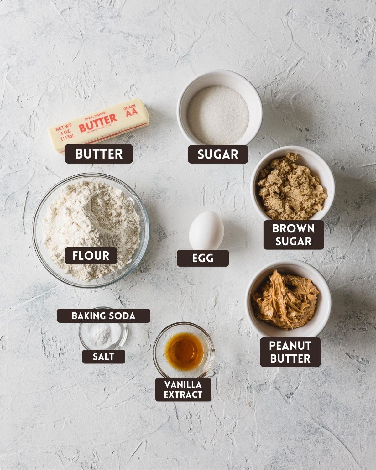 Labeled ingredients for peanut butter cookies: butter, sugar, brown sugar, flour, egg, peanut butter, baking soda, salt, and vanilla extract.