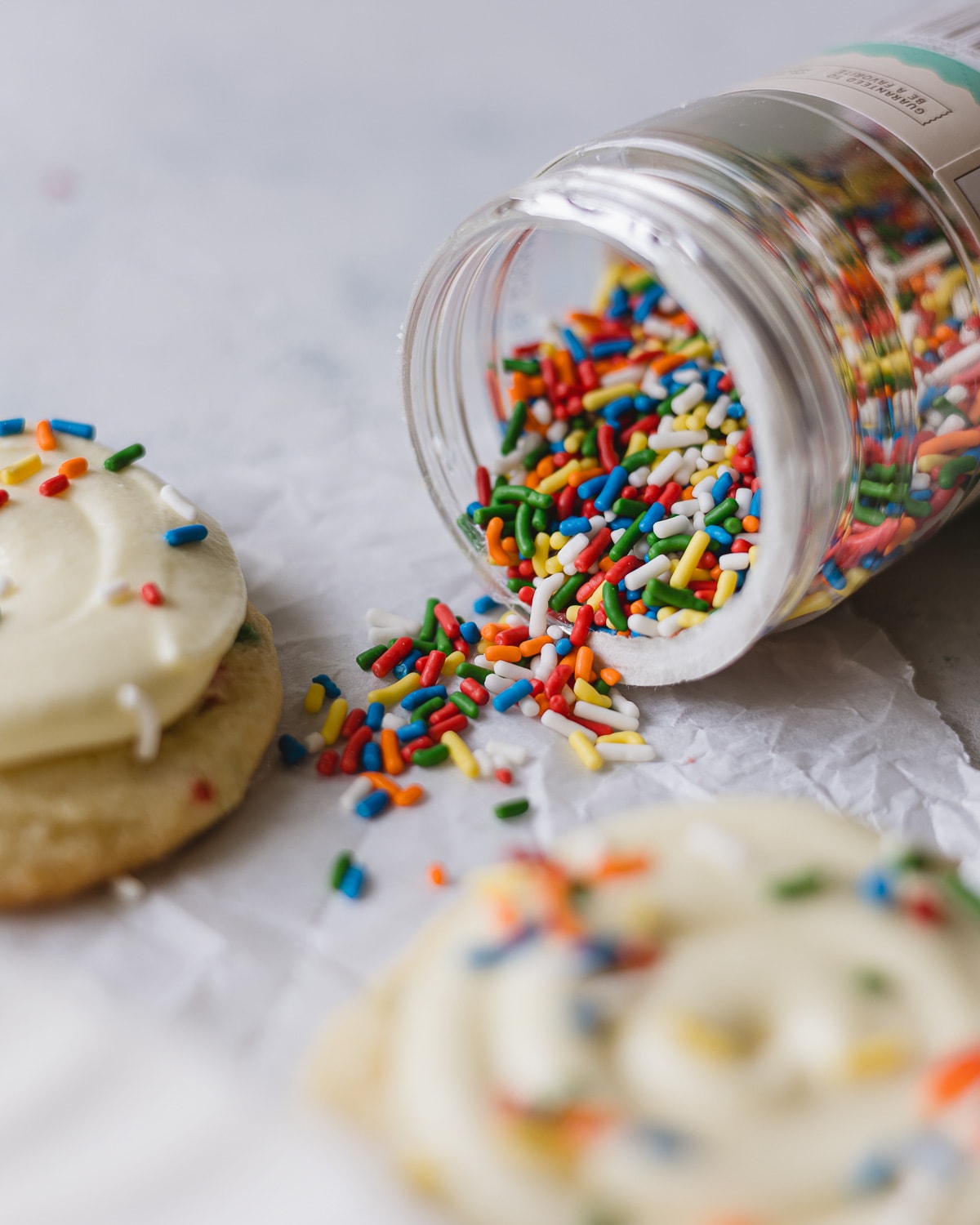 Colorful sprinkles pouring out of a jar.