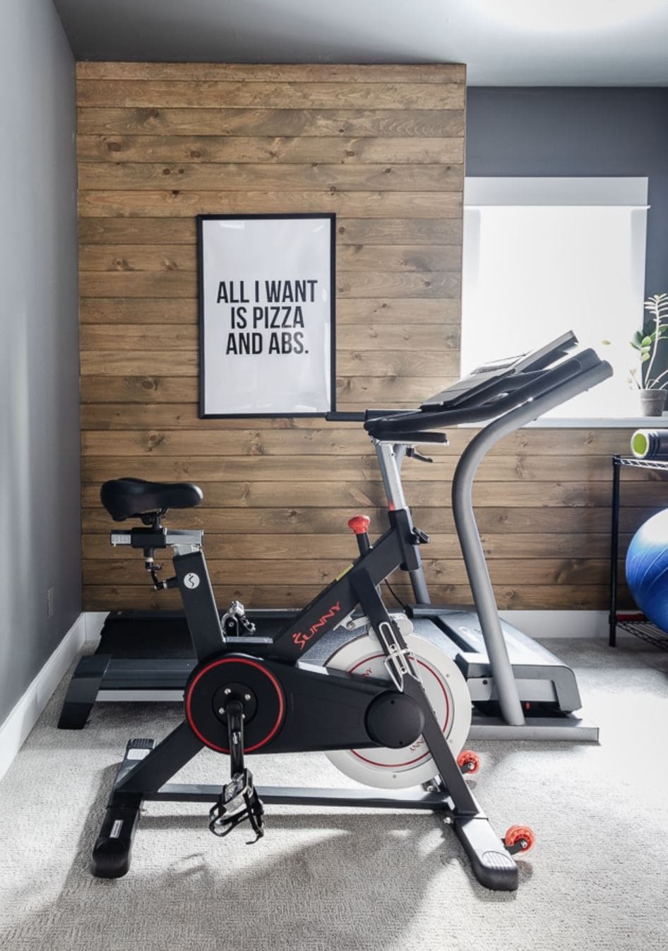 A workout area with a rustic wood planked wall.