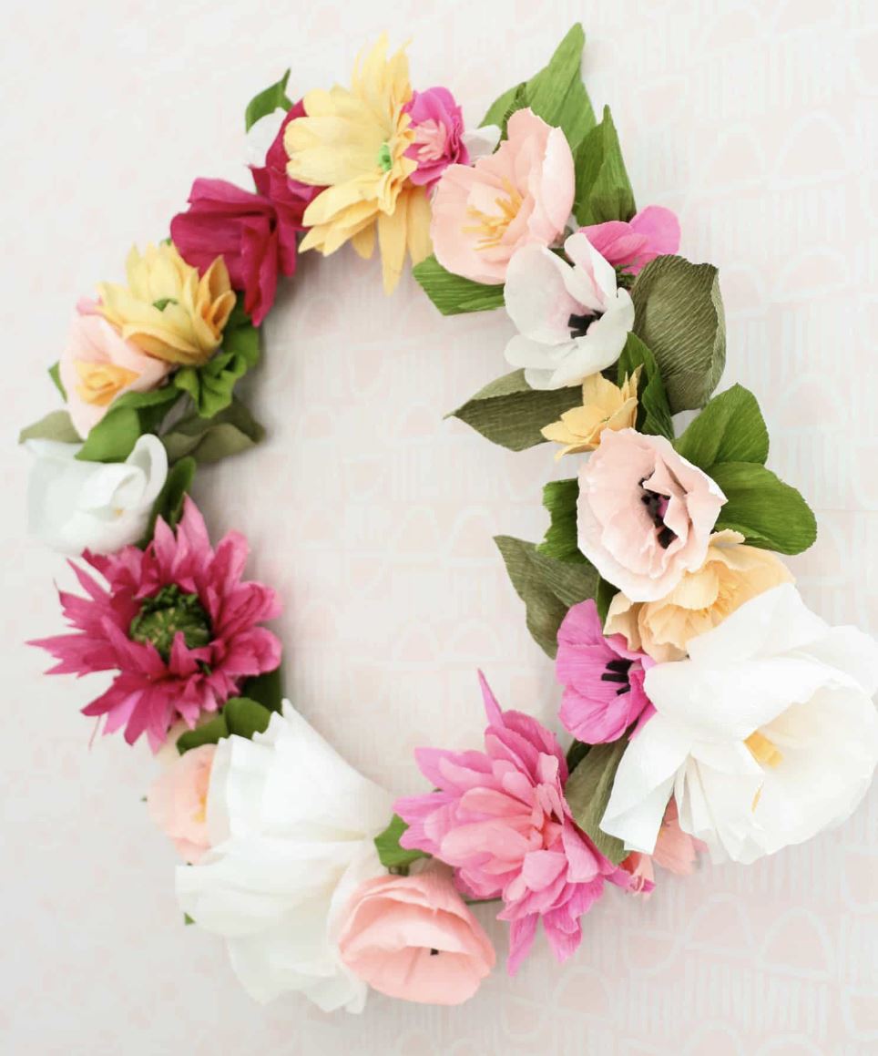 A pink, white, and yellow paper flower wreath.