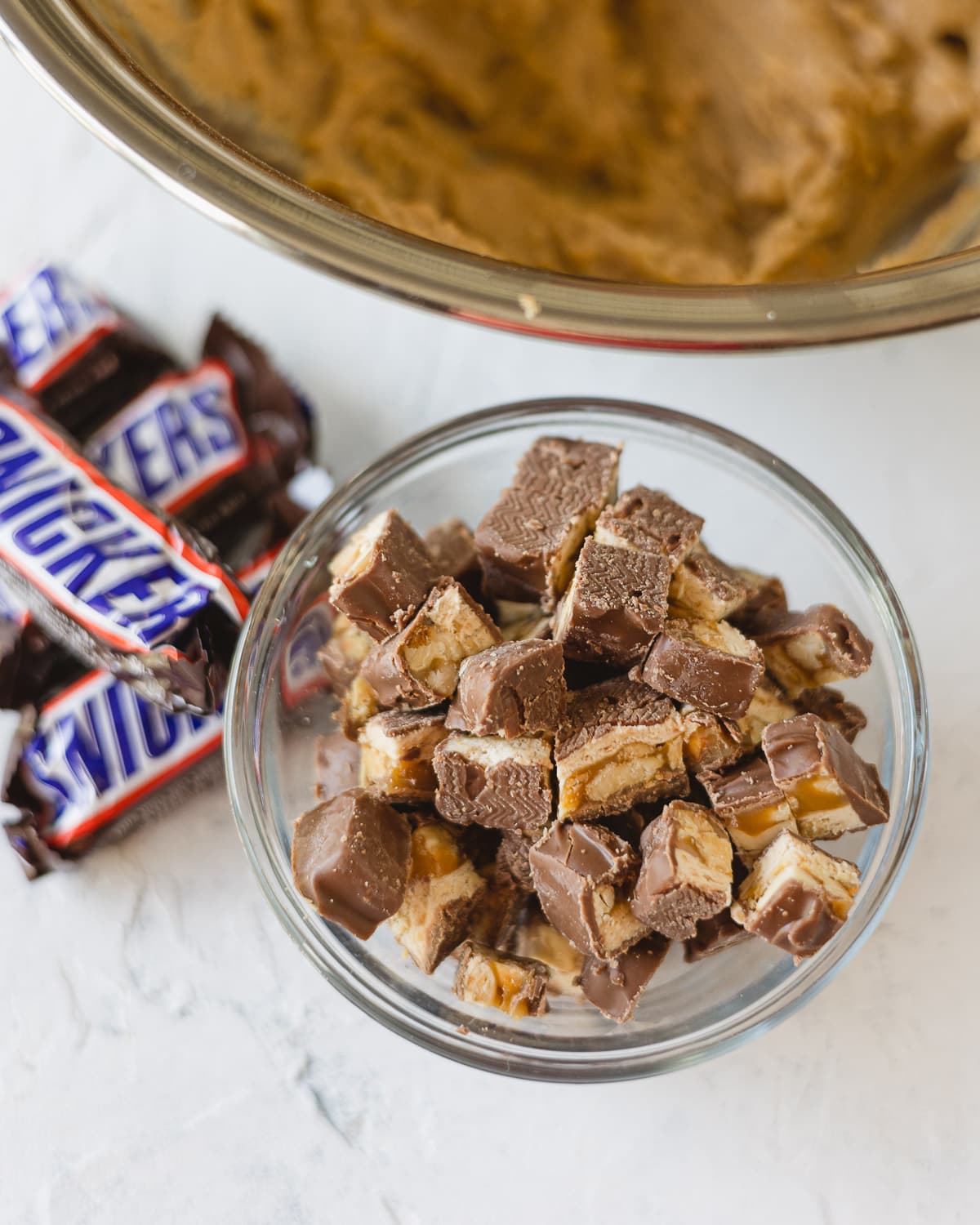 A small bowl of chopped Snickers candy bars.