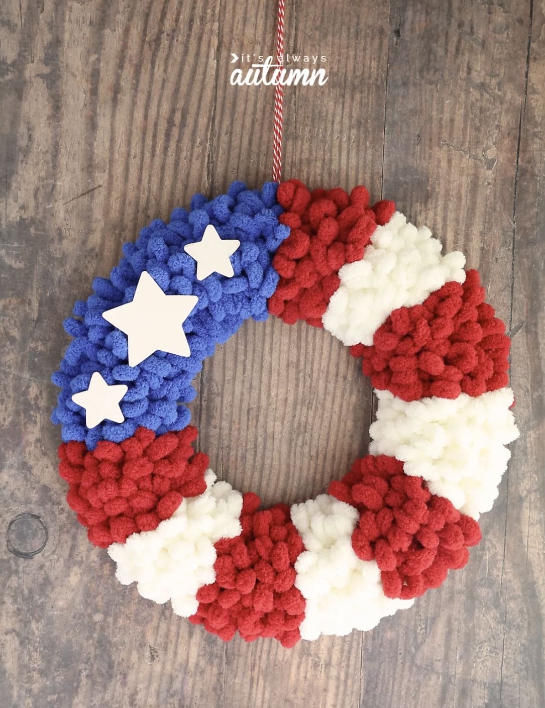 A red, white, and blue DIY yarn wreath.