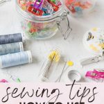 Various sewing supplies and a glass jar filled with colorful quilting clips with the words, "Sewing Tips: How to Use Quilting Clips."