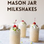 Three milkshakes in mason jars topped with whipped cream, sprinkles, and cherries, with the words, "Super Easy Mason Jar Milkshakes."
