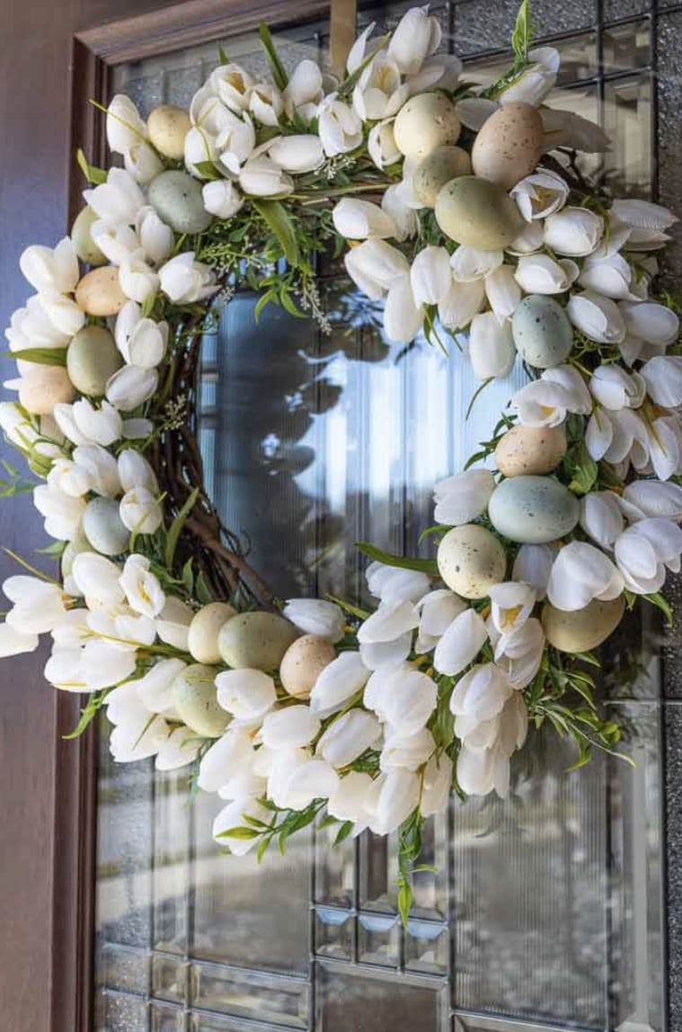 A spring wreath with tulips and Easter eggs.