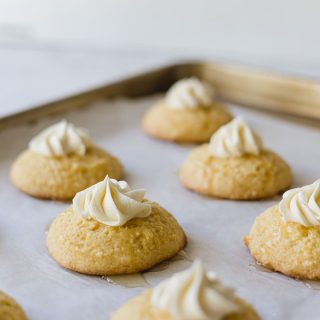 Cornbread Cookies topped with a piped star of honey buttercream and drizzled with honey butter.