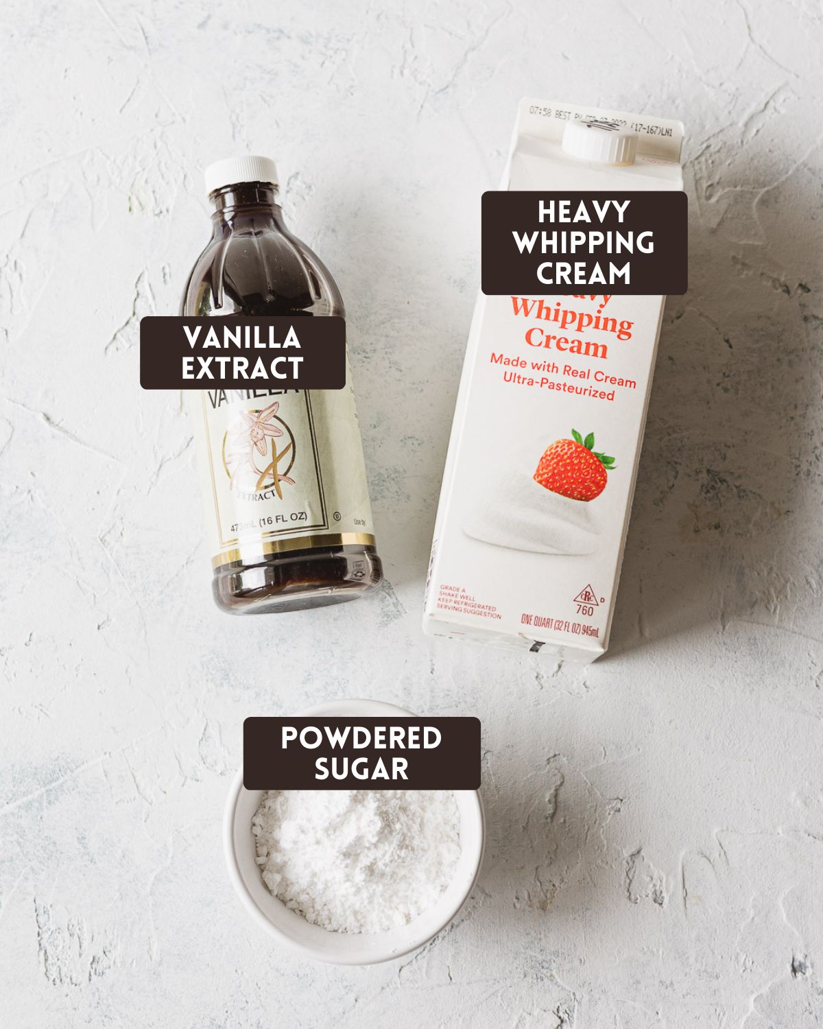 Labeled ingredients for whipped cream: vanilla extract, heavy whipping cream, and powdered sugar.