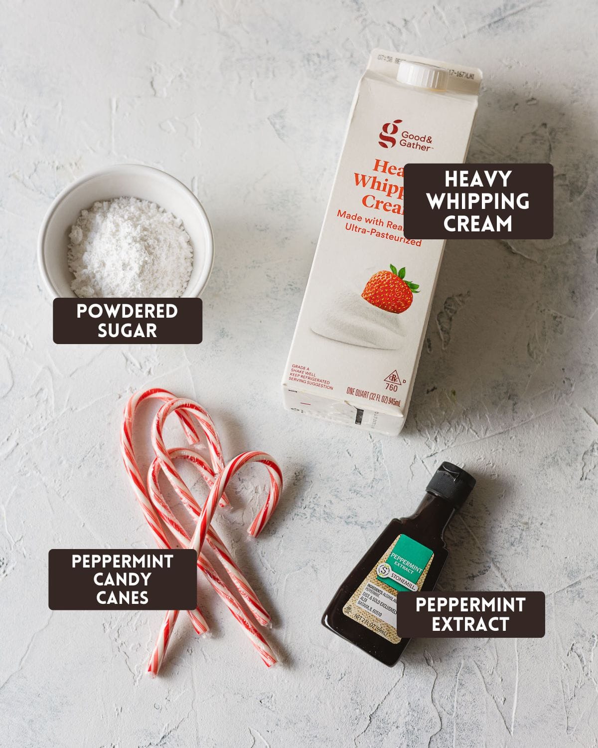 Labeled ingredients for candy cane whipped cream: powdered sugar, heavy whipping cream, peppermint candy canes, peppermint extract.