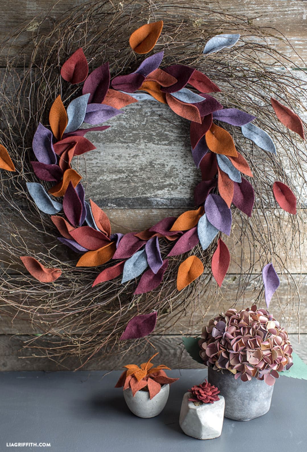 A fall wreath with colorful felt leaves.