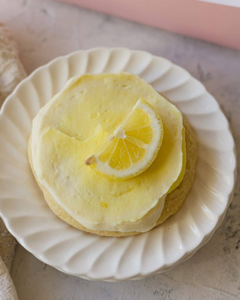 A Crumbl Lemonade Cookie with slice of fresh lemon on top.