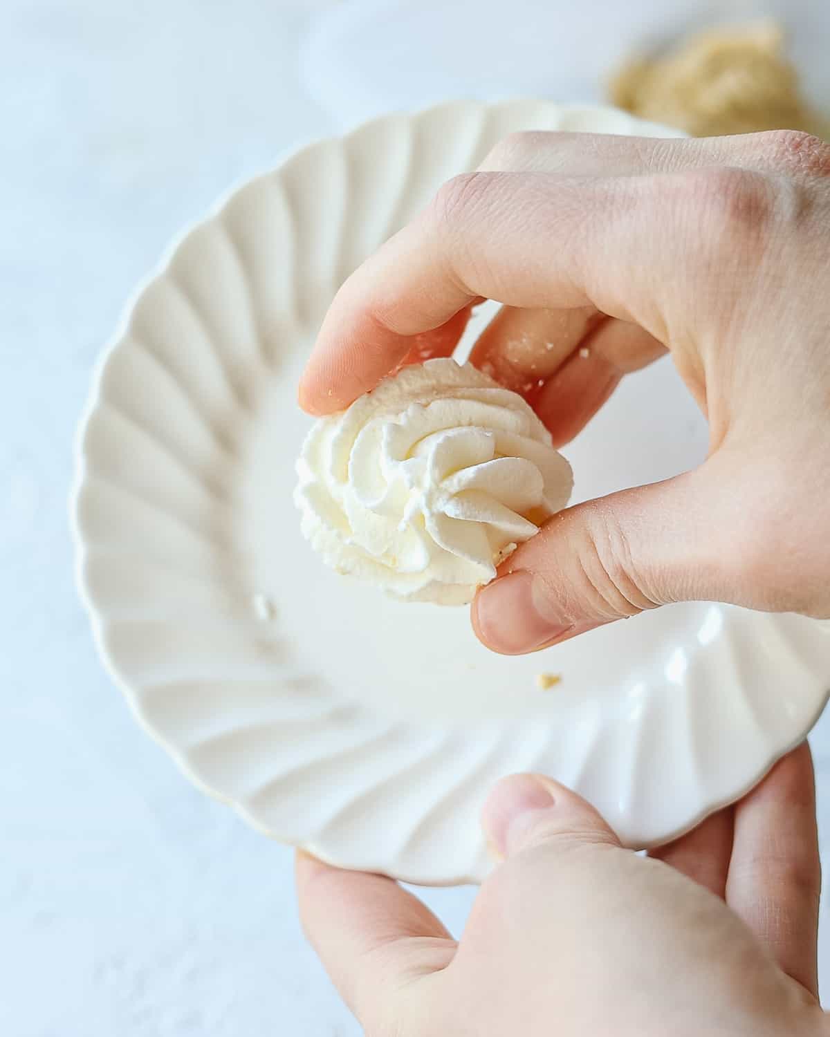 Holding a frozen rosette of homemade whipped cream.