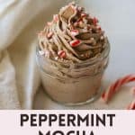A jar of piped chocolate peppermint mocha whipped cream topped with candy cane pieces with the words, "Peppermint Mocha Whipped Cream".