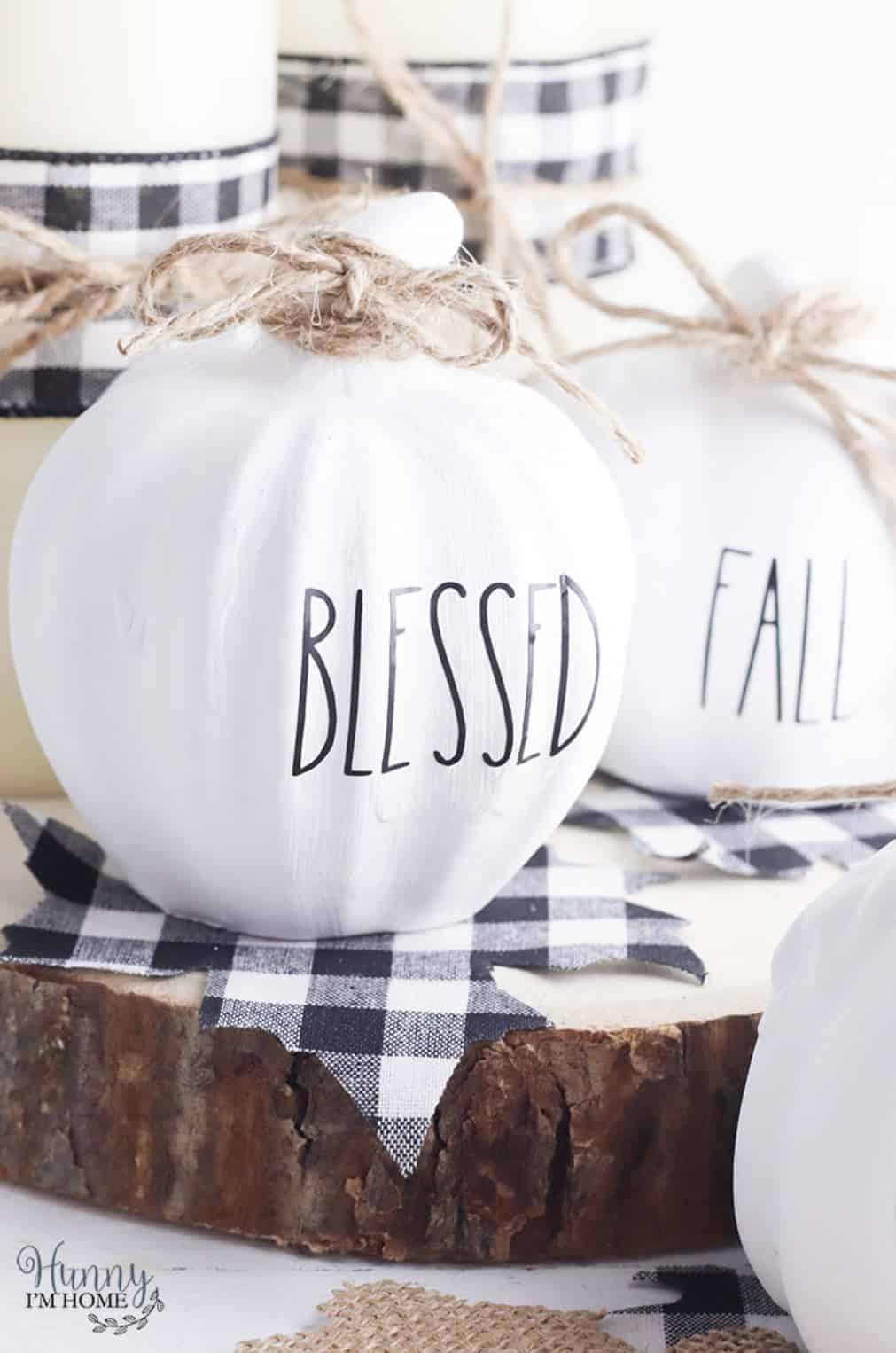 Decorative pumpkins painted white with letters added reading, "Blessed", and "Fall".