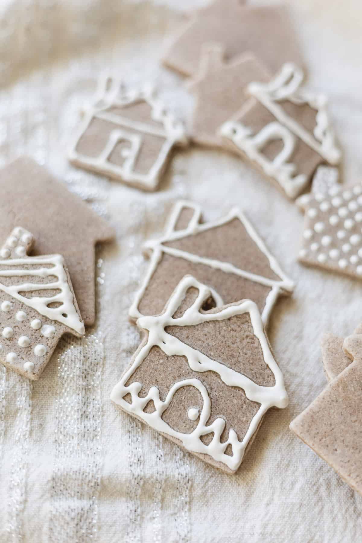 Salt dough house shapes decorated with white puffy paint.