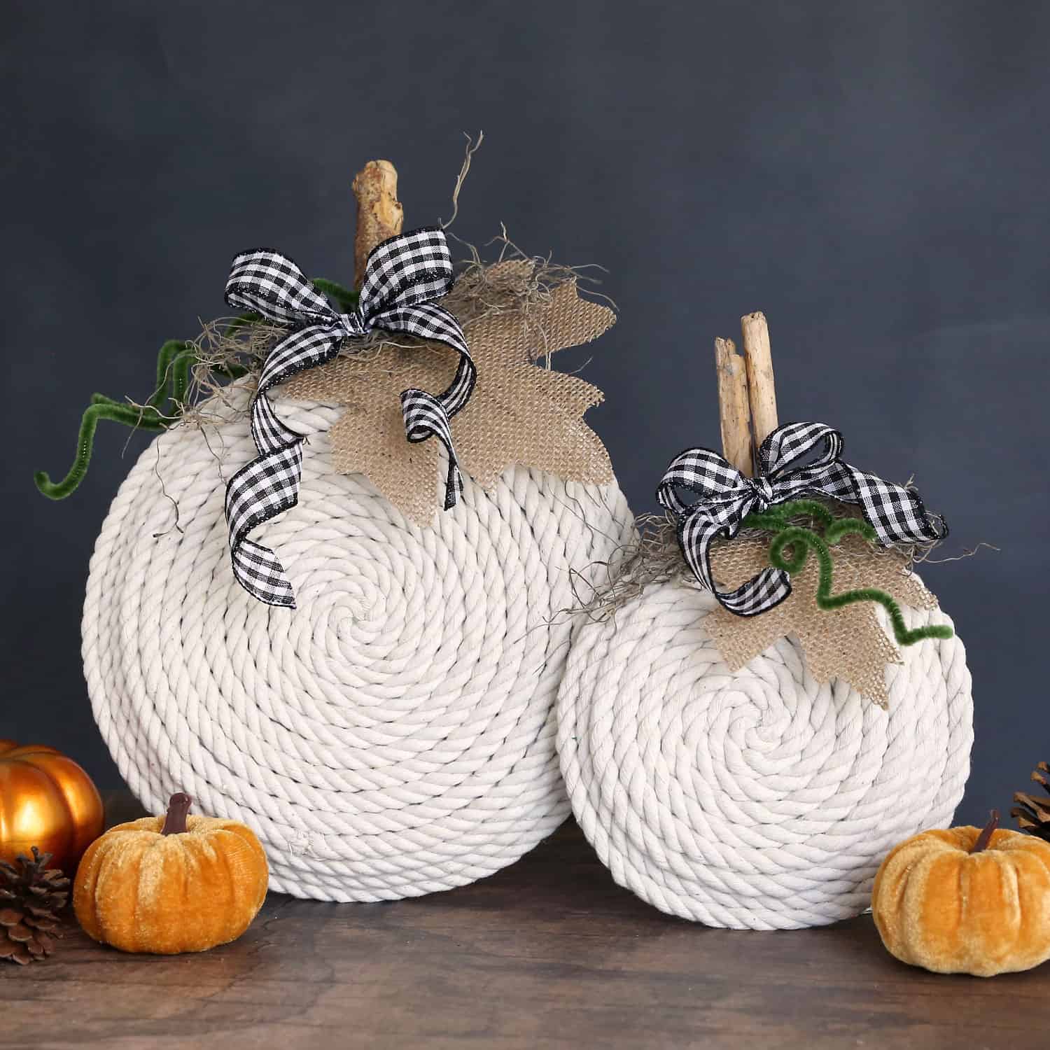 Rope formed into DIY pumpkins decorated with stems and black-and-white ribbon bows.