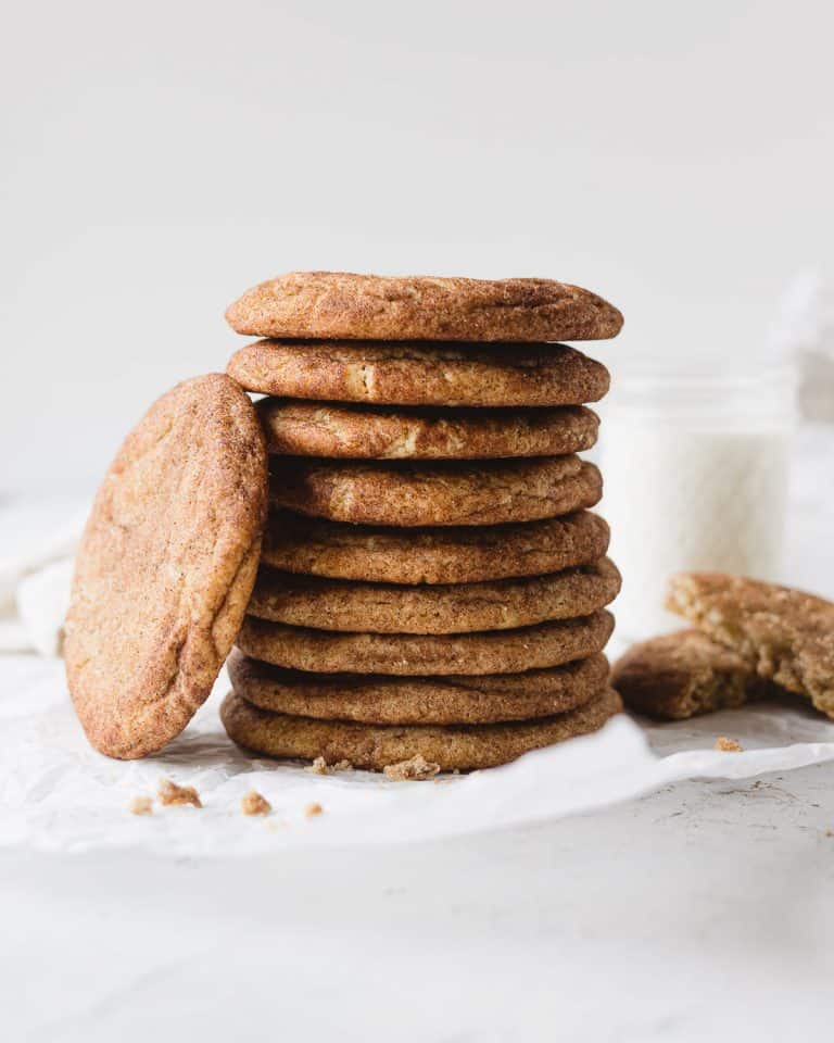 A stack of snickerdoodle cookies with a cookie leaning upright against the stack.