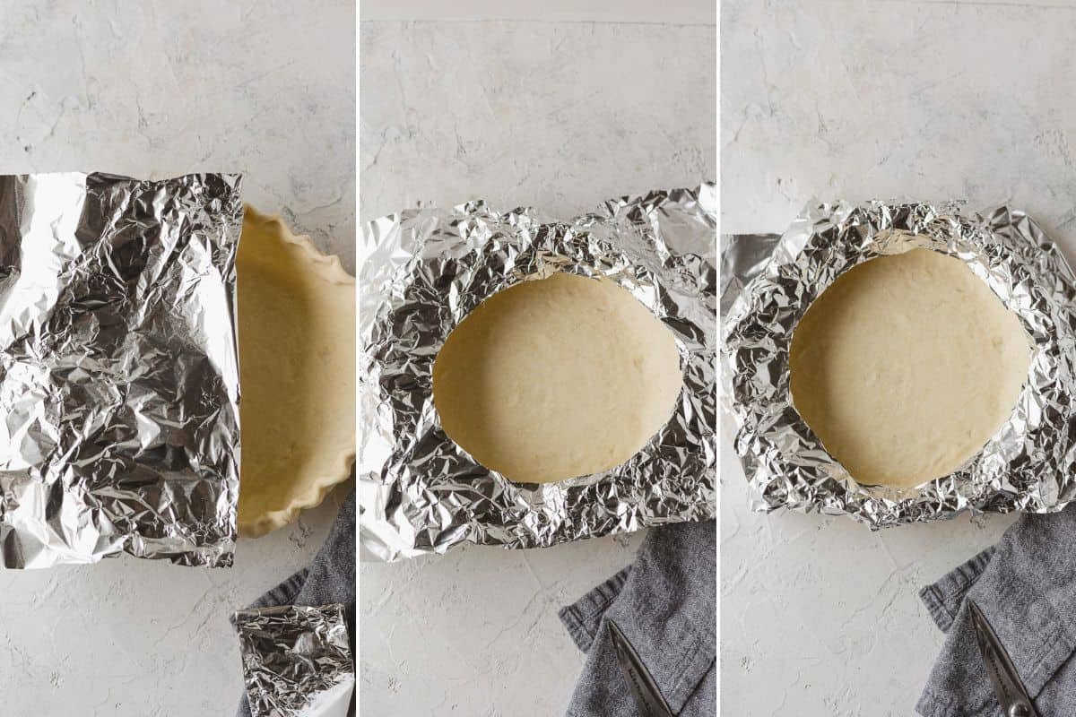 A sheet of tinfoil with half circles removed and shaped around the edges of a pie crust to form a homemade shield.