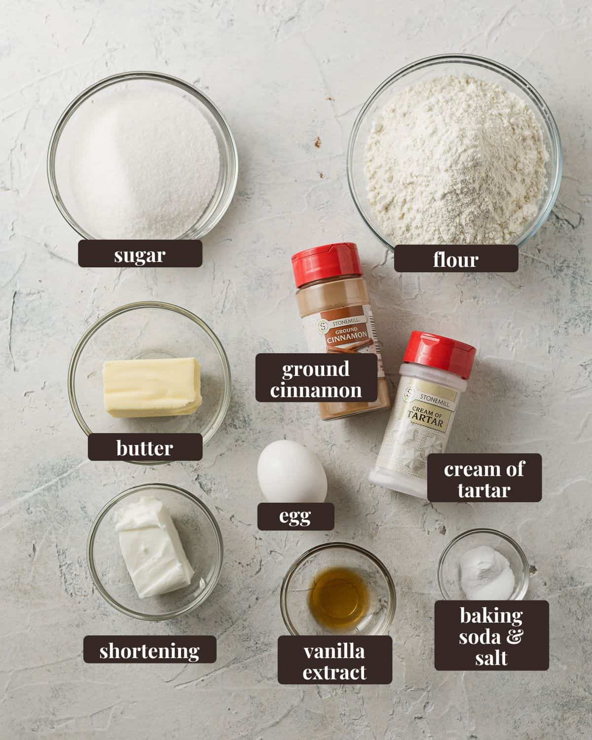 Labeled ingredients for Mini Snickerdoodle Cookies: sugar, flour, ground cinnamon, cream of tartar, baking soda & salt, vanilla extract, shortening, butter, and egg.