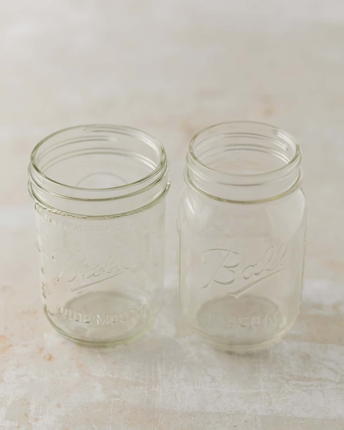 A wide-mouth 16-ounce jar and a regular-mouth 16 ounce jar.