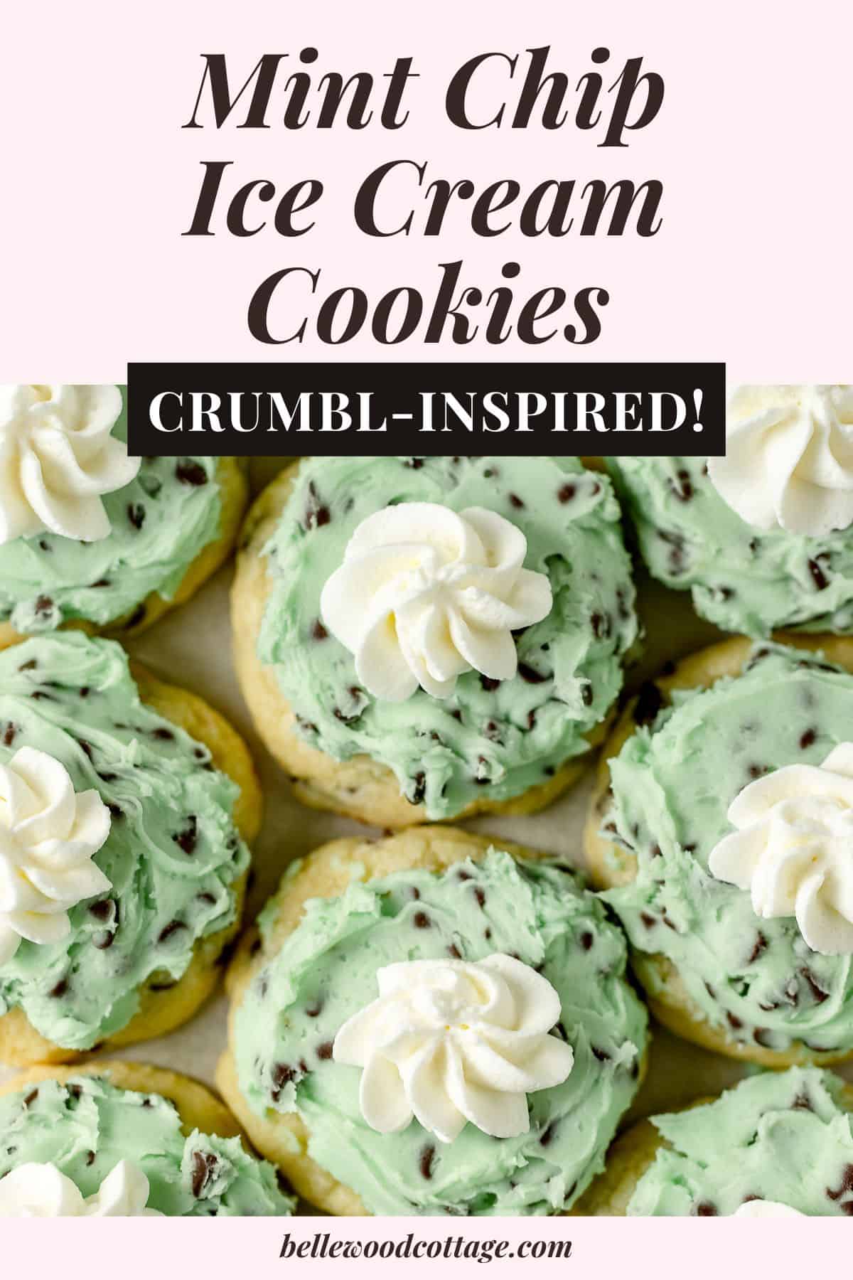 Sugar cookies frosted with green mint chocolate chip frosting and a piped rosette of whipped cream with the words, "Mint Chip Ice Cream Cookies - Crumbl Inspired".