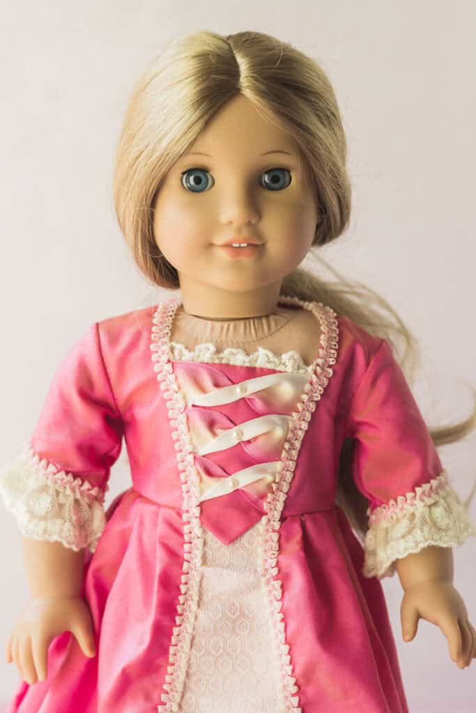 An Elizabeth AG doll wearing a pink dress.