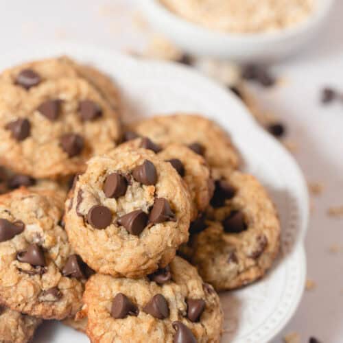 A ceramic plate filled with Coconut Oatmeal Chocolate Chip cookies.