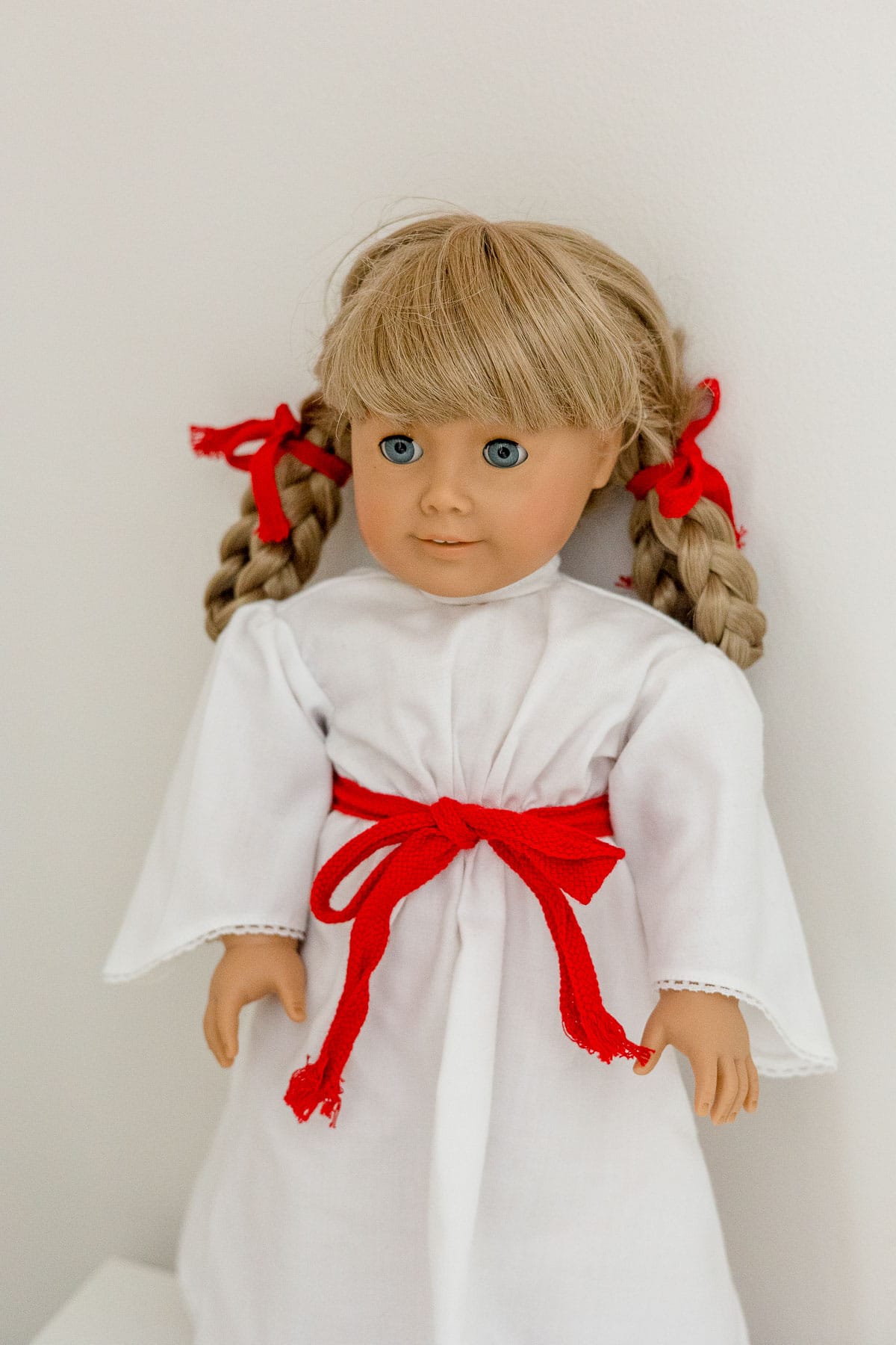 Pleasant Company Kirsten doll in white "St. Lucia" dress with red sash.