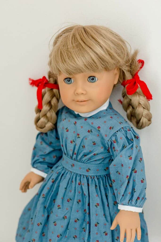 Pleasant Company Kirsten doll in blue floral "meet" dress with white trim.