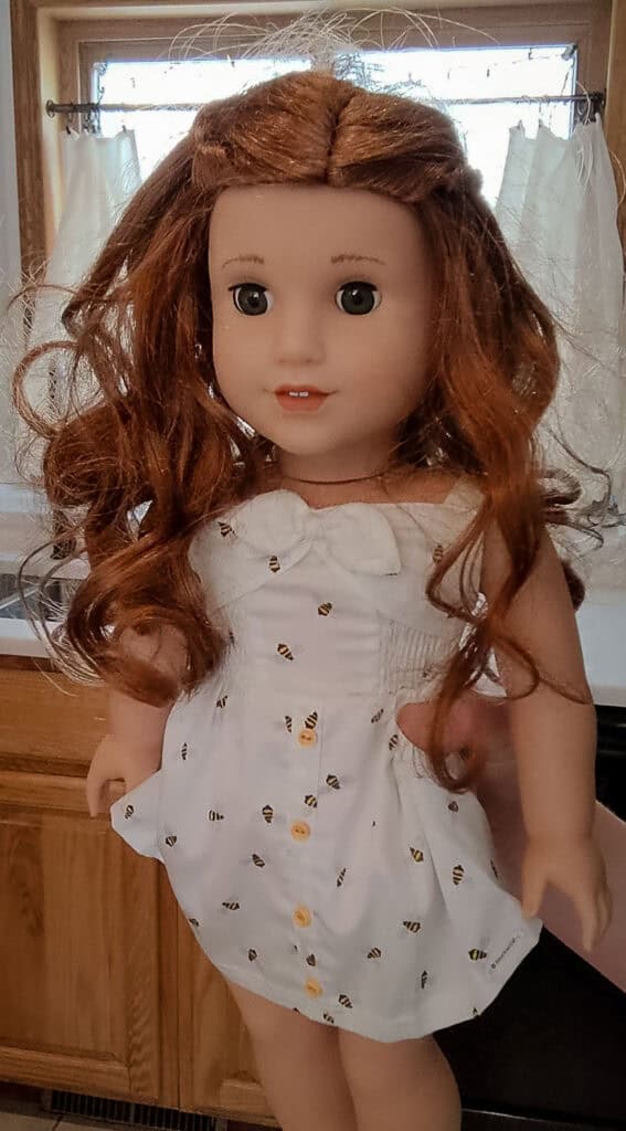 A "before" photo of an American Girl doll from the thrift store.